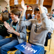 Chandler McMullen (right), 20, cheers as Yang speaks during the Reaching Rural Voters Rural Caucus Forum.
